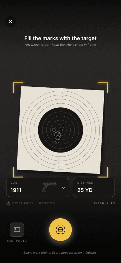 The RangeX camera framing a paper target between gold corner brackets.